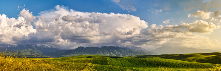 Fototapeta premium Panorama of a mountain valley in summer. Fabulous sunset in the mountains, amazing nature, summer in the mountains. Travel and camping, tourism