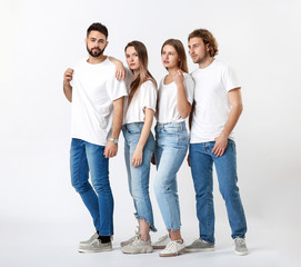 Fototapeta premium Stylish young people in jeans on white background