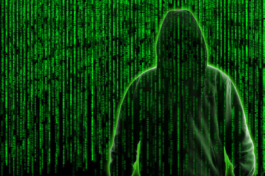 Conceptual image of a hacker on green programming code background