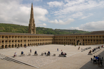 Halifax West Yorkshire UK, 10th May 2019: Photo of the famous Piece Hall in the Blackledge area of Halifax, showing the historic stone build building, taken on a part cloudy sunny day. - obrazy, fototapety, plakaty