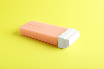 Liposoluble wax cartridge on color background