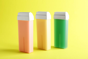 Liposoluble wax cartridges on color background