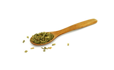 Dried chives chopped in a wooden spoon isolated on white background