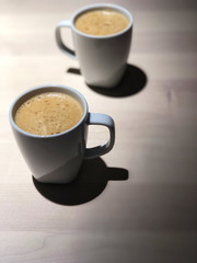 Best time to relax,Top view of Black coffee 2 cups on the wooden table with cafe light, Coffee time with special one.