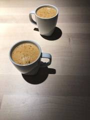 Best time to relax,Top view of Black coffee 2 cups on the wooden table with cafe light, Coffee time with special one.