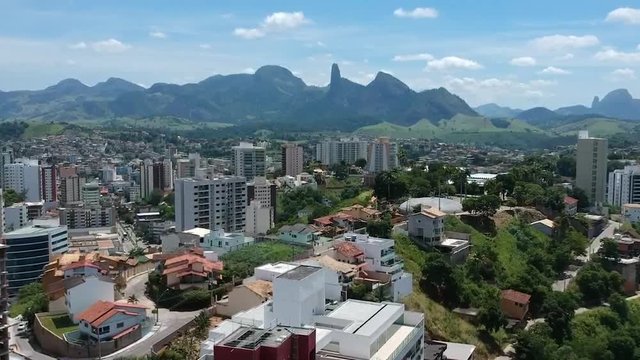 Aerial view over the buildings on a Brazilian small town. View of Pedra do Itabira and Frade e a Freira rock on Cachoeiro do Itapemirim.