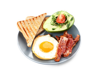 Plate with tasty fried egg, bacon, avocado and toasts on white background