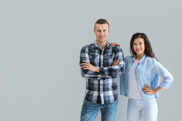 Naklejka premium Adorable loving couple on grey background