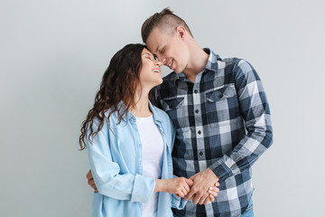 Adorable loving couple on grey background