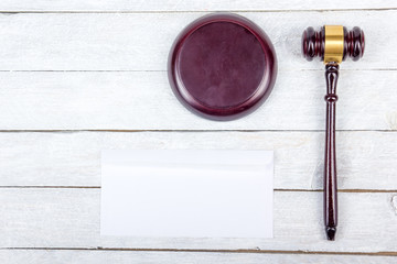 Law concept. Business card. Corporate stationery set mockup. Blank textured brand ID elements on wooden table, gavel. Top view. Office desk tabl.