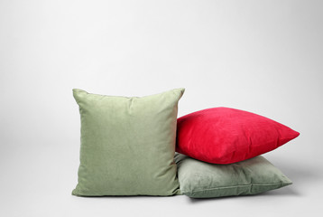 Stylish pillows on grey background