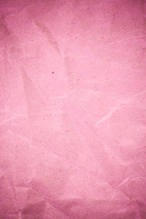 Pink crumpled recycle paper background.