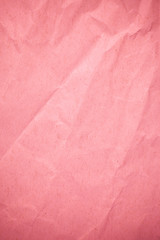 Crumpled recycle pink paper background.