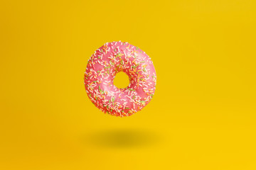 pink donut on yellow background