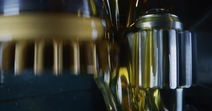 Slow motion macro of specialist is working on production of different gearing details in a workshop in industrial factory.