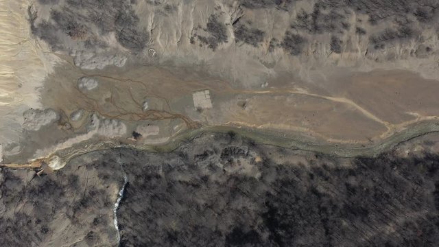 Drainage from the mine with pyrite on river coast 4K aerial video