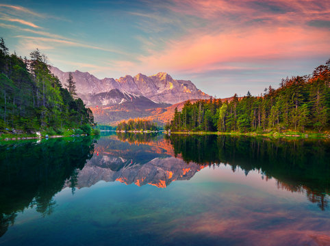 Impressive summer sunrise on the Eibsee lake with Zugspitze mountain range. Splendid outdoor scene in German Alps, Bavaria, Garmisch-Partenkirchen village location, Germany, Europe.