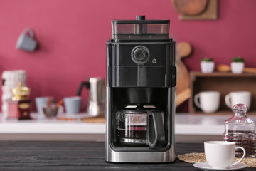 Modern coffee machine on kitchen table