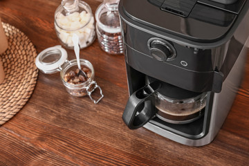 Modern coffee machine on kitchen table