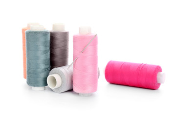 Colorful sewing threads on white background