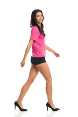 Fototapeta premium Beautiful Young Woman Is Walking And Laughing