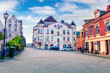 Naklejka premium Nice view of street of Alesund town on the west coast of Norway, at the entrance to the Geirangerfjord. Colorful morning cityscape. Traveling concept background.