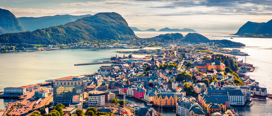 Fototapeta premium From the bird's eye view of Alesund port town on the west coast of Norway, at the entrance to the Geirangerfjord. Colorful morning scene of the Nord. Traveling concept background.
