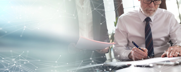 Senior manager working with executive assistant; multiple exposu