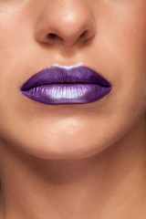 Close up view of beautiful woman lips with glossy lipstick.