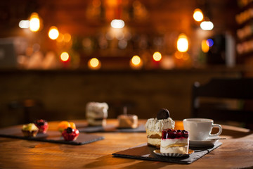 Gorgeous view of different cakes with different flavours over a wooden board in a coffee shop