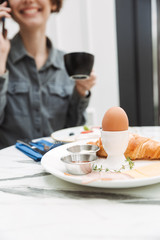 Attractive young girl having breakfast