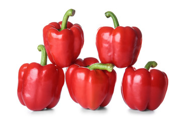 Ripe red peppers on white background