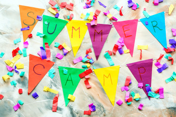 Garland with text SUMMER CAMP and decor on marble background