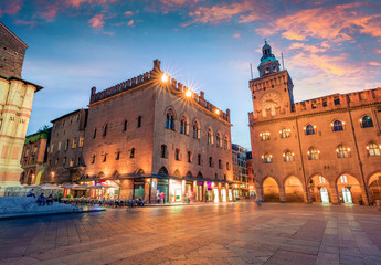 Great spring sunset of the main square of City of Bologna with Palazzo d'Accursio and facade of Basilica di San Petronio. Great cityscape of Bologna, Italy, Europe. © Andrew Mayovskyy