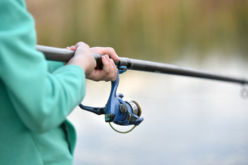 child boy holds fishing rod