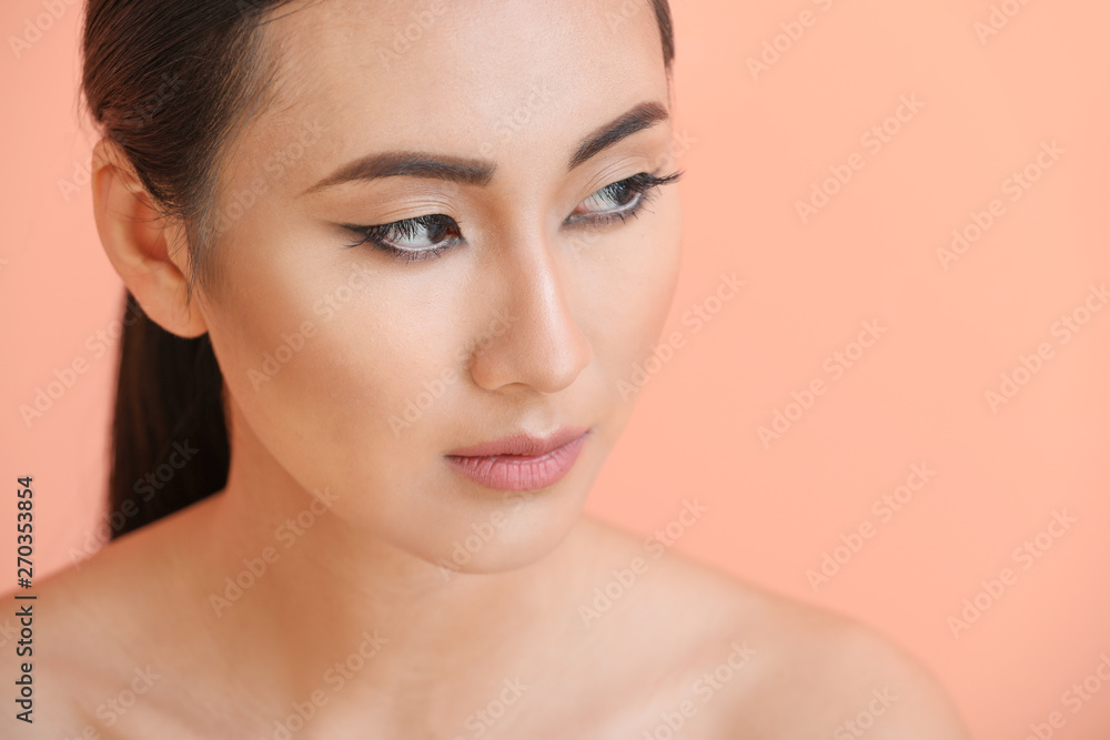 Poster Asian woman with beautiful makeup on color background