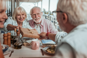 Pleased elderly woman looking at her friend