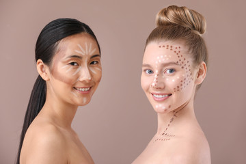 Young women with contouring makeup on color background