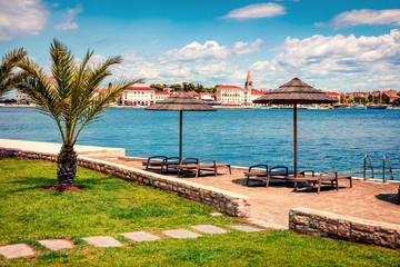 Fototapeta premium Sunny spring view of popular summer resort Porec. Colorful spring seascape of Adriatic Sea. Great morning scene of Istrian Peninsula in western Croatia, Europe. Vacation concept background.