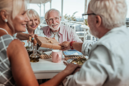 Positive delighted mature couple having family dinner