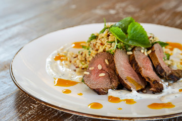 Lamb tenderloin served with barley salad