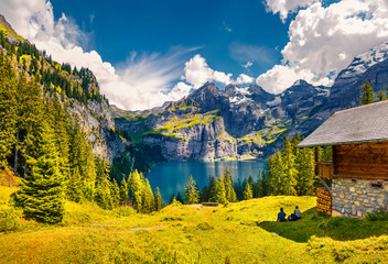 Colorful summer morning on the unique Oeschinensee Lake. Splendid outdoor scene in the Swiss Alps with Bluemlisalp mountain, Kandersteg village location, Switzerland, Europe.