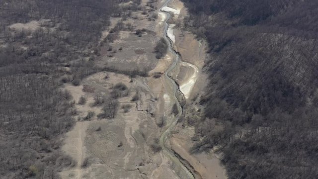 Polluted river stream with pyrite on the coast 4K drone footage