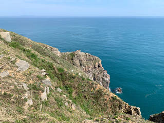Russia, Vladivostok. The rocky shore of the island of Shkot in the archipelago of the Empress Eugenie in sunny spring day