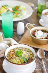 Healthy organic vegetarian dishes and glasses of detox drinks served on the restaurant table, casual dining restaurant food