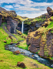 Colorful morning view of Kvernufoss waterfall. Majestic summer scene of south Iceland, Europe....