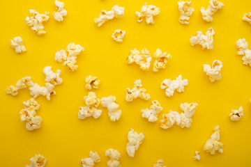 Popcorn pattern, texture on a yellow background. Top view, entertainment, movie
