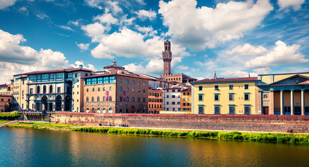 Sunny spring cityscape of Florence with Old Palace (Palazzo Vecchio or Palazzo della Signoria) on background. Colorful morning scene in Italy, Europe. Traveling concept background.