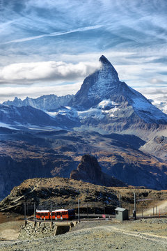 Zermatt Switzerland. Famous electric red tourist train coming down