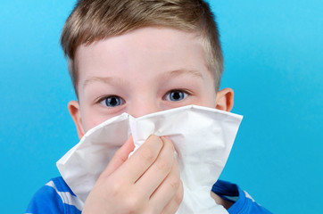 portrait of boy with handkerchief, blue background